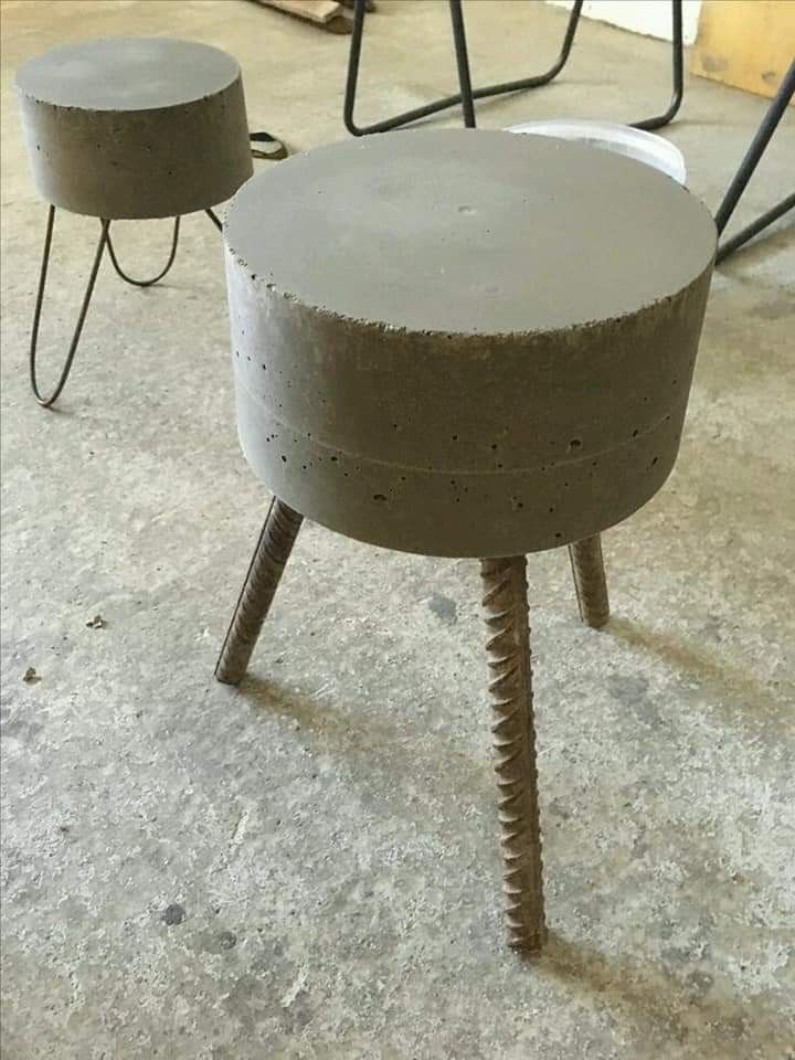 two concrete stools sitting on top of a cement floor