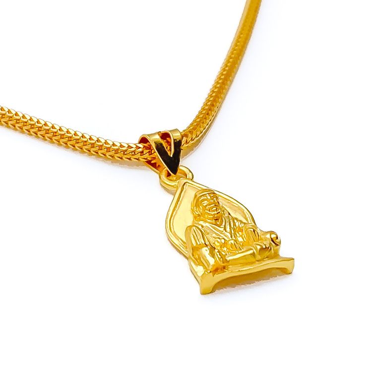 This attractive pendant, exquisitely crafted from 22k gold and weighing 3.2 grams, features a finely engraved depiction of Sai Baba set against a luminous yellow gold finish. The pendant has a length of 0.9 inches, making it both noticeable and modest in size, ideal for daily wear. Perfect for devotees who wish to keep Sai Baba close to their hearts, this pendant combines spiritual devotion with elegant craftsmanship, offering a timeless piece that embodies grace and serenity. PRODUCT DETAILS Gold Purity(karat): 22k Gold Weight(grams): 3.2 Item Finish: Yellow Gold Pendant Length: 0.9" Chain: Not Included Yellow Gold Amulet Necklace For Rituals, 22k Gold Amulet Locket Jewelry, Gold Pendant Necklace For Rituals, Yellow Gold Round Pendant For Puja, Yellow Gold Round Pendant Temple Necklace, Gold Plated Pendant Necklace For Diwali, Gold Temple Jewelry Necklaces As Gift, Gold Jewelry With Large Pendant For Rituals, Traditional Yellow Gold Pendant Necklace