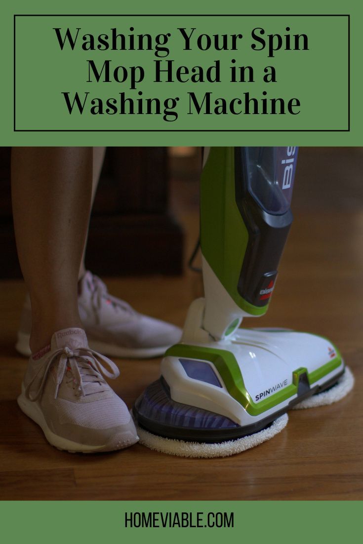 a person using a floor scruber on top of a wooden floor with the words washing your spin mop head in a washing machine