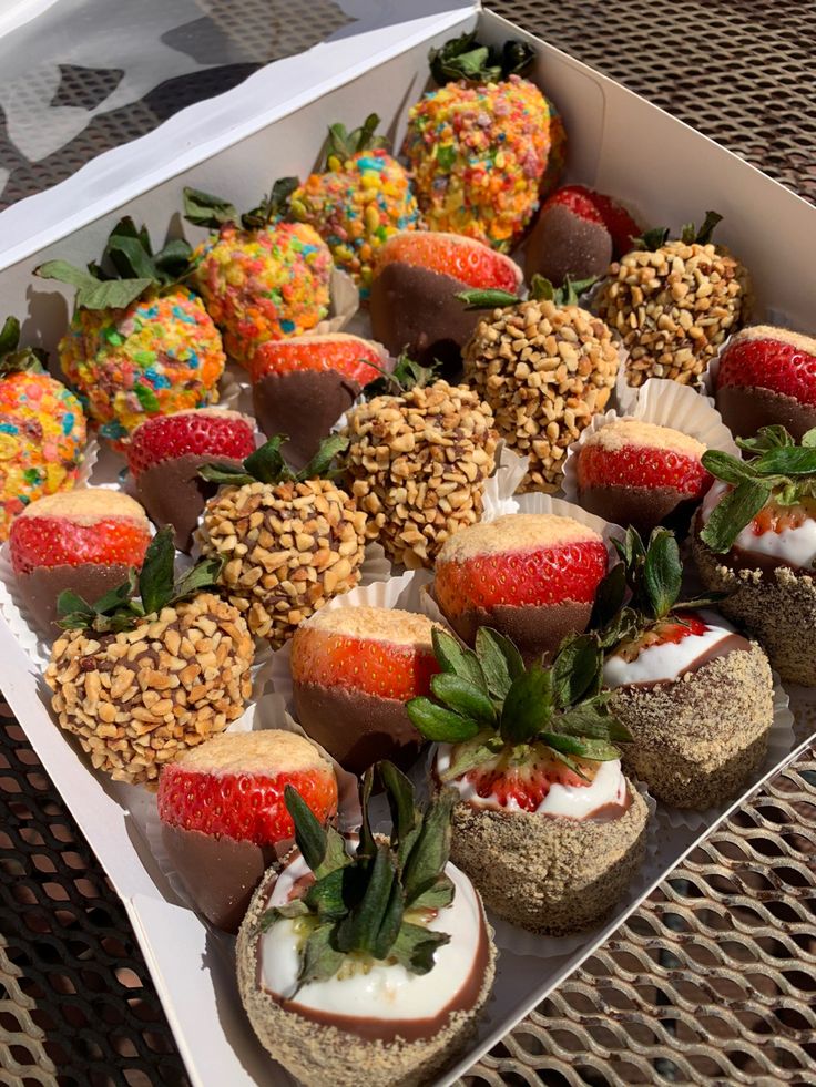 a box filled with lots of different types of desserts on top of a table