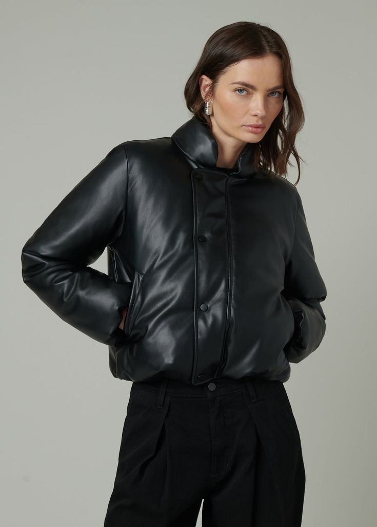 Slightly cropped jacket with a bubble hem that combines traditional styling and puffer detailing. DETAILS + FIT Slightly cropped fit Bubble hem Covered zip & snap closure Elastic hem & sleeve opening Soft vegan leather with added stretch for comfort. 100% Vegan leather with polyester backing Hand wash Turn the jacket inside out to protect the fabric from abrasion. Lay them flat in the sink or bathtub and rinse thoroughly with cold water to remove all suds. Spot clean when needed with a damp clot Puffy Leather Jacket, Cropped Leather Jacket For Winter Streetwear, Winter Cropped Jacket With Button Closure, Cropped Quilted Outerwear For Fall, Black Cropped Outerwear With Button Closure, Chic Cropped Jacket With Padded Collar, Fitted Cropped Jacket With Padded Collar, Cropped Puffer Outerwear For Fall, Fall Cropped Puffer Outerwear