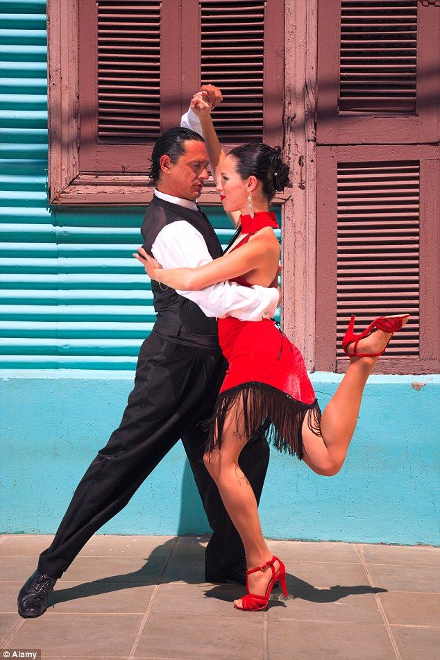 a man and woman dancing on the street