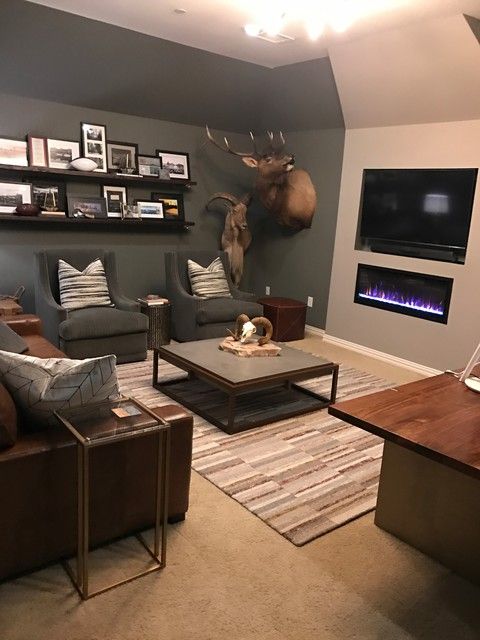 a living room filled with furniture and a fire place in the center of the room