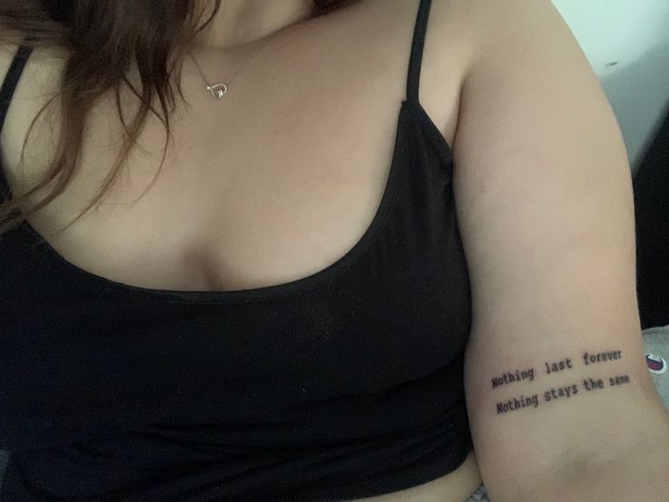 a woman with a small tattoo on her left arm and the words, nothing just knows making things like me