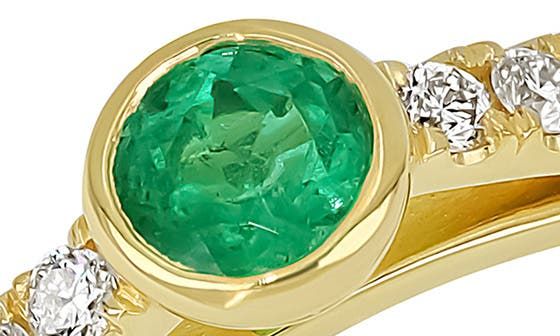 Dainty trios of round-cut diamonds draw the eye to the stunning bezel-set emerald atop this slender band cast in radiant 18-karat gold. 1/8" round setting Total emerald weight: 0.18ct. Total diamond weight: 0.09ct. Color: G Clarity: VS 18k gold/emerald/diamond Made in the USA >Diamond Guide Luxury Emerald Ring With Tension Setting, Elegant Yellow Gold Emerald Ring With Channel Set, Luxury Emerald Ring With Tension Setting For Anniversary, Luxury Anniversary Emerald Ring With Tension Setting, Timeless Round Emerald Ring With Bezel Setting, Luxury Bezel Set Diamond Ring For May Birthstone, Luxury Round Emerald Ring With Bezel Setting, Formal Emerald Ring With Channel Set Round Cut, Formal Channel Set Round Cut Emerald Ring