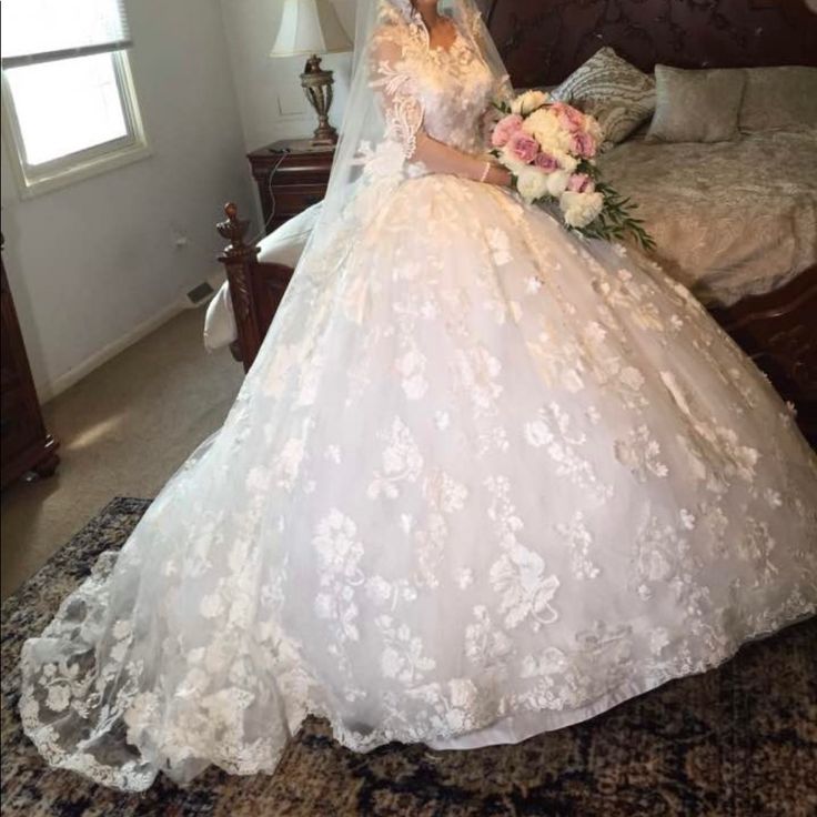 a woman in a wedding dress sitting on a bed