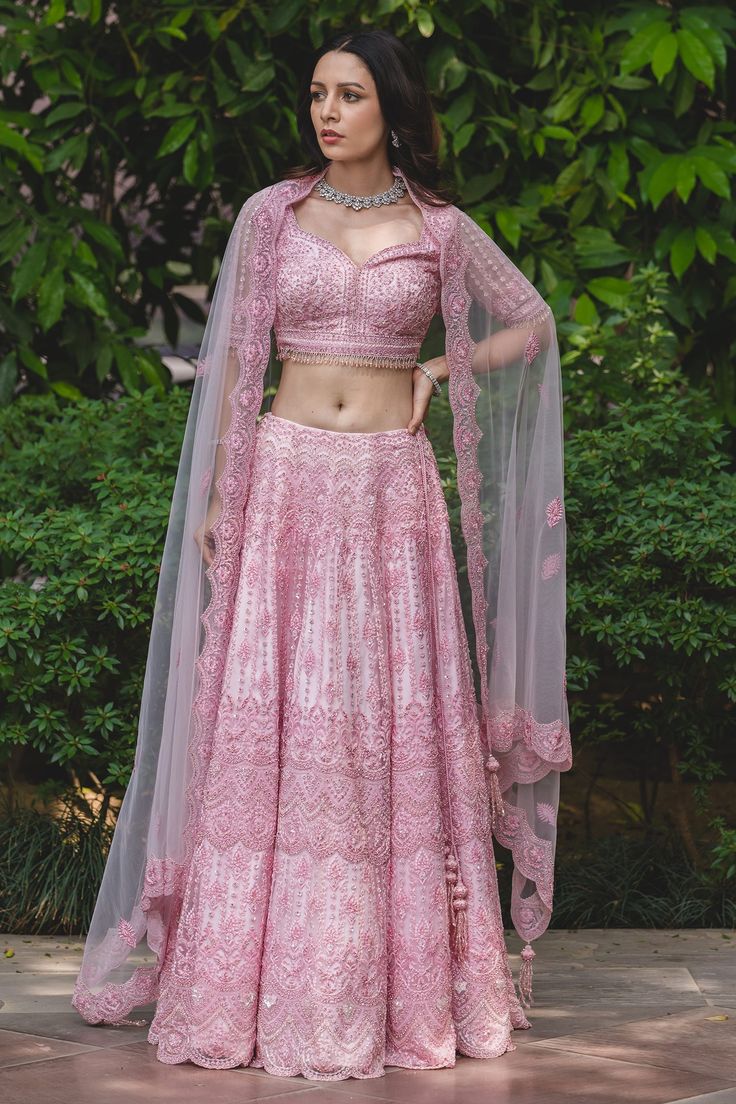 Powder pink lehenga with attached cancan, highlighted with tonal resham embroidery and embellishments. Comes with sweetheart neckline padded blouse and dupatta.
Component: 3
Embroidered
Neckline: Sweetheart
Sleeve Length: Elbow
Fabric: Tulle
Color: Pink
Sequin, beads, cutdana and crystal embroidery
Embroidered blouse with beaded tassels at the sleeves and hem
Tie-up at the back with latkans
Scallop edged hem lehenga
Embroidered dupatta - Aza Fashions Pink Net Lehenga With Traditional Drape, Pink Net Sharara With Traditional Drape, Traditional Pink Net Lehenga, Traditional Drape Pink Net Lehenga, Pink Net Sharara For Diwali, Festive Pink Net Sharara, Pink Net Lehenga With Resham Embroidery, Pink Net Sharara With Resham Embroidery, Pink Net Choli For Diwali