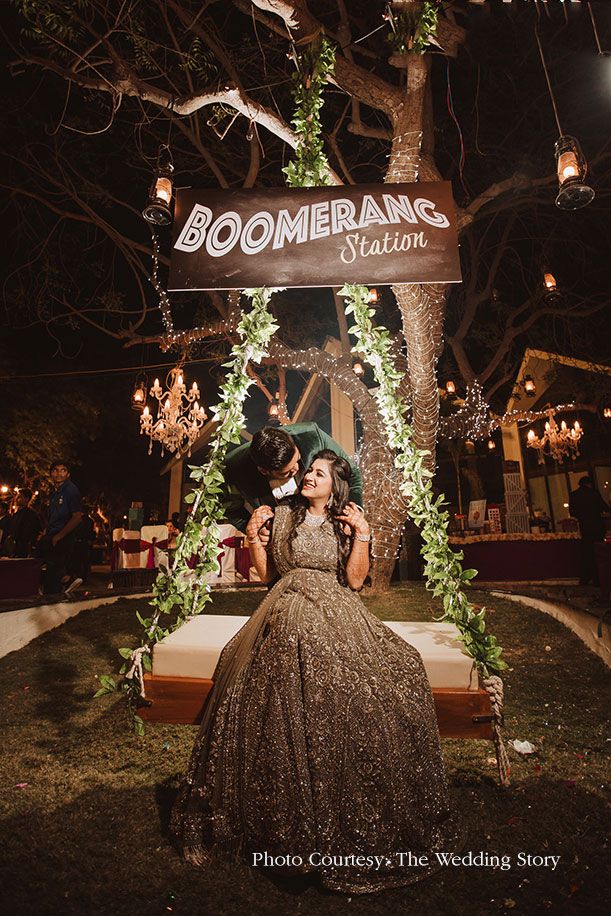 a woman in a dress sitting on a bench under a sign that says boomeran's station