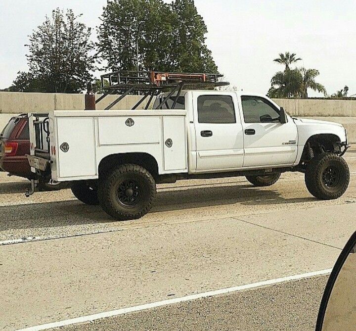 a white truck parked on the side of a road