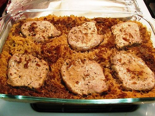 a casserole dish with chicken and rice in it