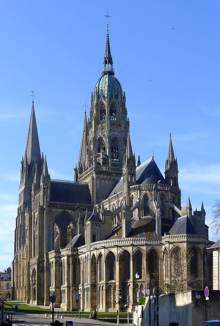 an old building with many spires on the front and side of it is shown