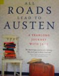 the book all roads lead to austen is sitting on a table next to a chair