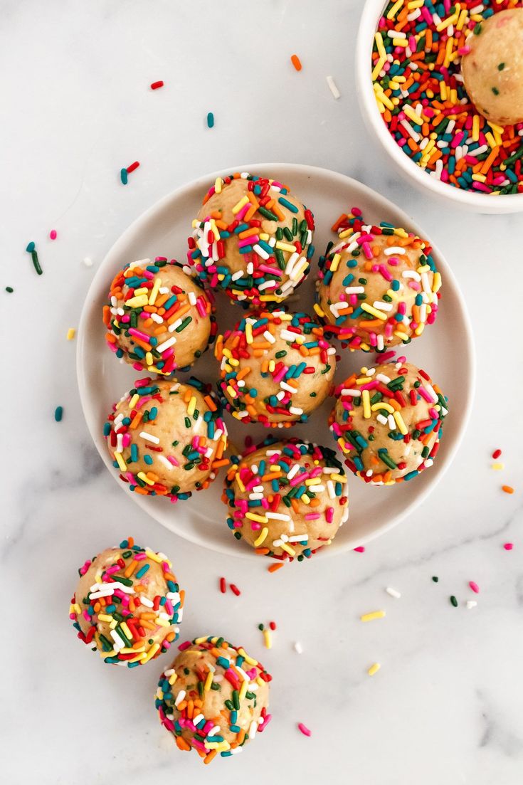 birthday cake protein balls on a plate with sprinkles