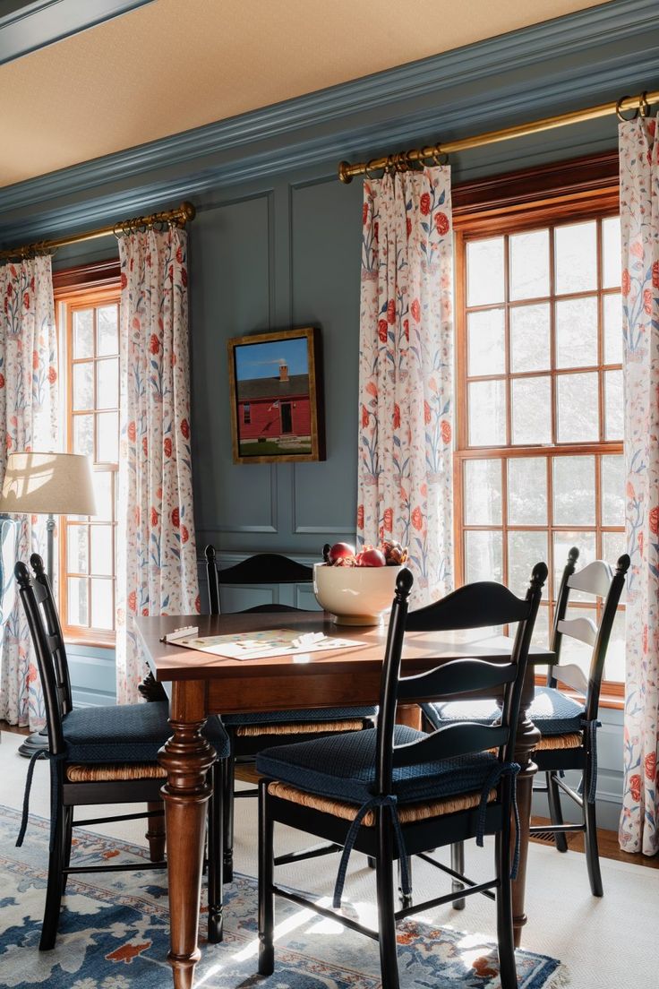 a dining room table with four chairs around it