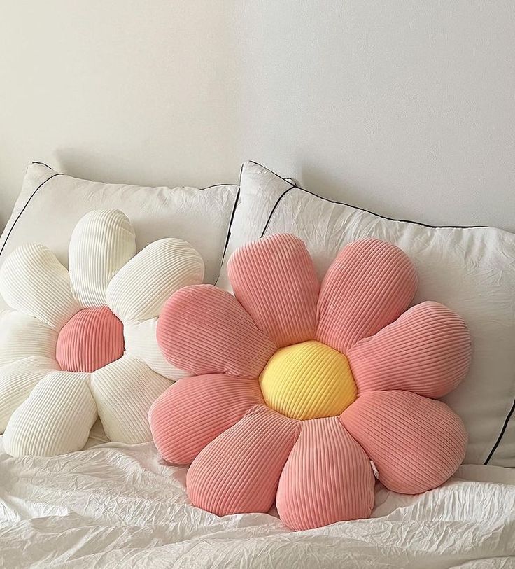 a bed with pillows made to look like flowers