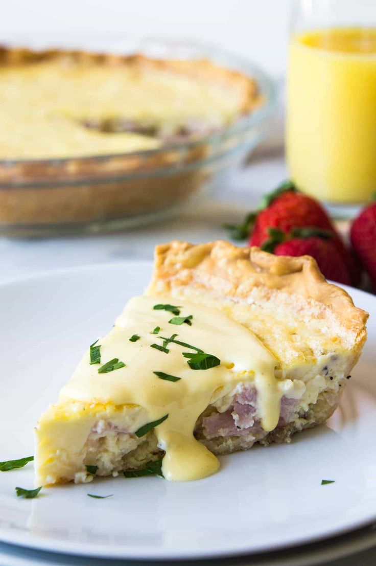 a slice of quiche on a plate with strawberries