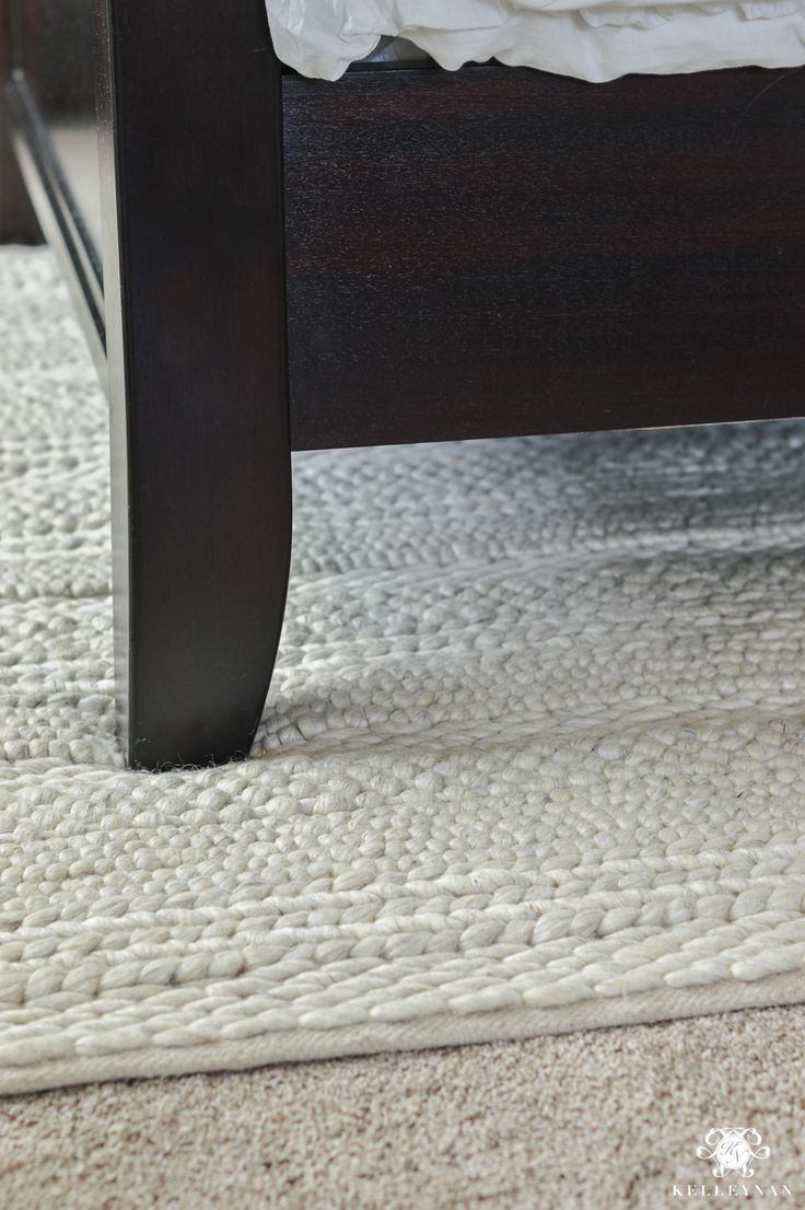 a close up of a bed with a wooden headboard and foot board on the floor