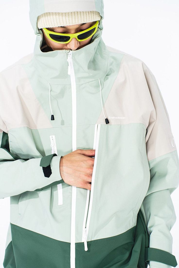 Discover the fusion of cutting-edge design and practicality with the Asymmetric Water-Proof Windbreaker. Crafted to provide exceptional waterproof capabilities, this jacket is a staple for the style-conscious adventurer. The futuristic paneled design lends a modern edge, while the dual zippers under the arms ensure ample breathability during vigorous activities. Attention to detail is evident in the "right as rain" embroidered text on the cuffs, adding a unique character to this functional piece Utility Clothing, Technical Apparel, Urban Jacket, Embroidered Text, Fresh Color Palette, Fresh Color, Outdoor Fashion, Outdoor Jacket, Jacket Design