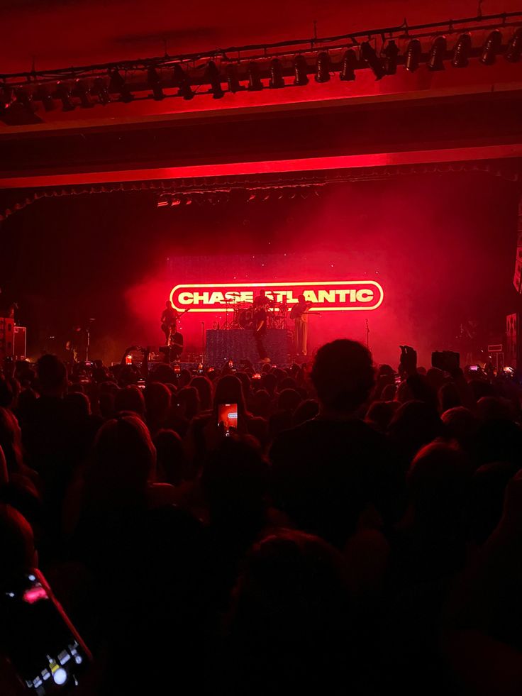 a large group of people in front of a stage with red lights and the words ottawa theatre on it