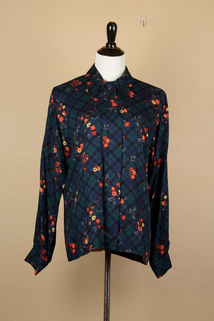 "Vintage 1980s Long Sleeve Button Shirt by Country Sophisticates, Pendleton, Portland Oregon: This vintage long sleeve button up shirt is made from a soft and comfortable fabric that exudes quality. The shirt features hidden buttons down the front, ensuring a clean and polished look. What sets this blouse apart is its lovely and unique floral and plaid print. The floral and plaid patterns seamlessly blend together, creating a natural and effortlessly wearable aesthetic. The design showcases a ma Formal Plaid Shirt For Fall, Vintage Shirt For Office In Fall, Vintage Office Shirt For Fall, Vintage Fall Office Shirt, Classic Floral Print Shirt For Fall, Classic Floral Print Fall Blouse, Classic Floral Print Blouse For Fall, Rayon Top, Floral Blazer