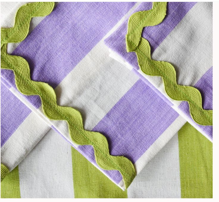 three pieces of fabric with green trim on them