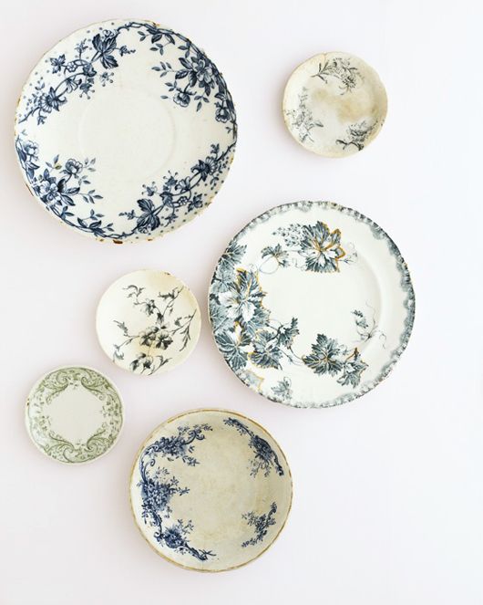 four plates with blue and white designs on them