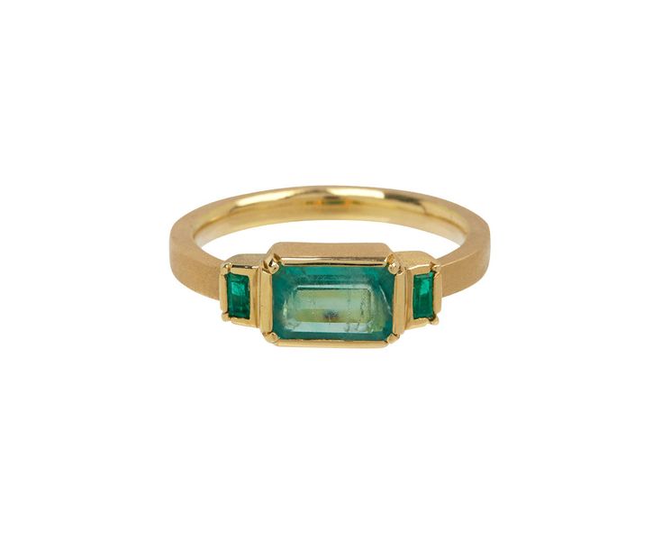 Striking in its monochromatic color, this Brooke Gregson ring is perfect as an alternative to the traditional engagement ring or as an everyday right hand ring. The center rectangular emerald is set in a hand fabricated 18K yellow gold bezel and centered on the 18K yellow gold band between two additional baguette emeralds. emeralds : vary : 3mm x 2mm to 5mm x 8mm each : 1.17cttw18K yellow gold band width : 2mmsize available : 6.75please contact us for sizing options Fine Jewelry Rectangular Emerald Ring, Rectangular 14k Gold Emerald Promise Ring, Rectangular Emerald Jewelry With Bezel Setting, Classic Rectangular Emerald Ring With Bezel Setting, Rectangular Gold Emerald Ring With Bezel Setting, Luxury Yellow Gold Emerald Ring With Square Cut, Elegant Rectangular Emerald Signet Ring, 14k Yellow Gold Emerald Ring With Rectangular Stone, Square Cut Emerald Gold Rings