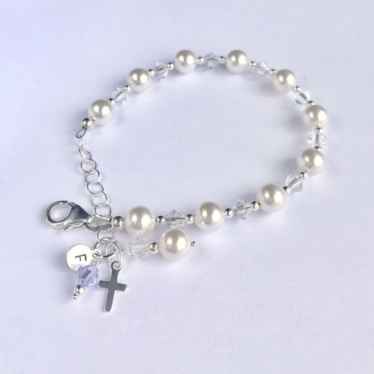 This lovely First Communion bracelet and earrings set is sure to be the perfect gift! The beautiful bracelet doubles as a single decade rosary. This classic bracelet has been a big seller as First Communion jewelry, Confirmation jewelry, Easter bracelet, Flower Girl gift, Maid-of-Honor jewelry, Bridesmaids matching bracelets, Mother-of-the-Bride jewelry, Godmother gift, and as Bridal jewelry. Description: -Bracelet measures 5 ½ inches plus a 1-inch extension chain -fits First Communion age (2nd Round Pearl Crystal Bracelet For Gift, Personalized White Dangle Jewelry, Dainty Hypoallergenic Rosary Bracelet Gift, Elegant Adjustable Rosary Bracelet For Birthday, Adjustable Pearl Jewelry For Gifts, Sterling Silver Rosary Bracelet Gift, Sterling Silver Rosary Bracelet With Round Beads As Gift, Sterling Silver Rosary Bracelet With Round Beads, Hypoallergenic Pearl Jewelry For Birthdays