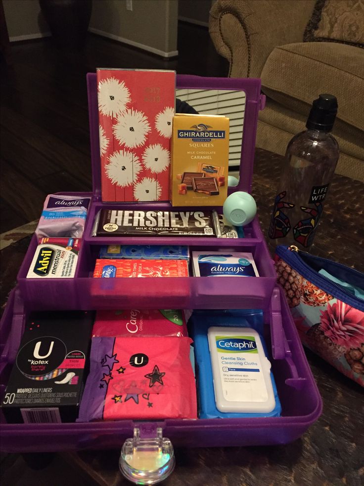 a purple suitcase filled with books and other items