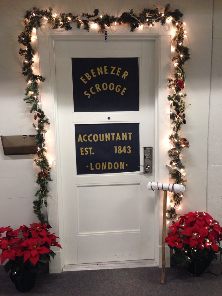 a door decorated with christmas garland and poinsettis