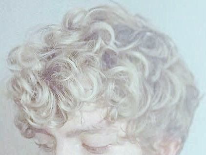 a close up of a person with curly hair