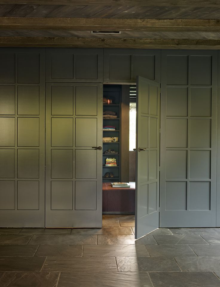 an open door leading into a room with gray walls