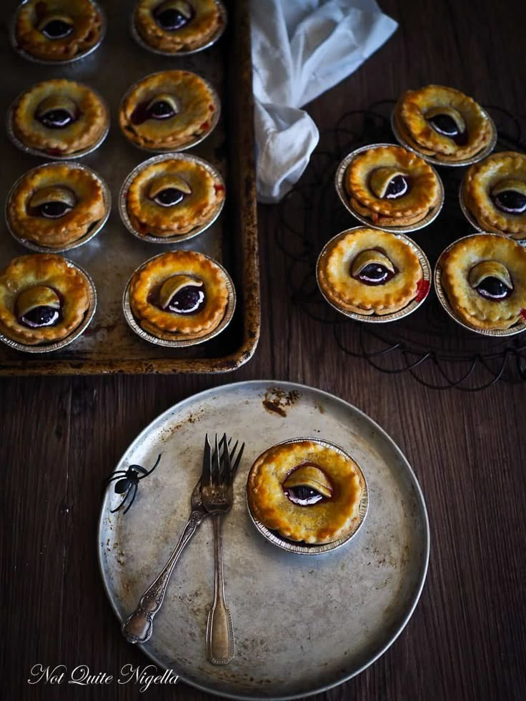 baked pastries on trays ready to be eaten with fork and knife next to baking pan