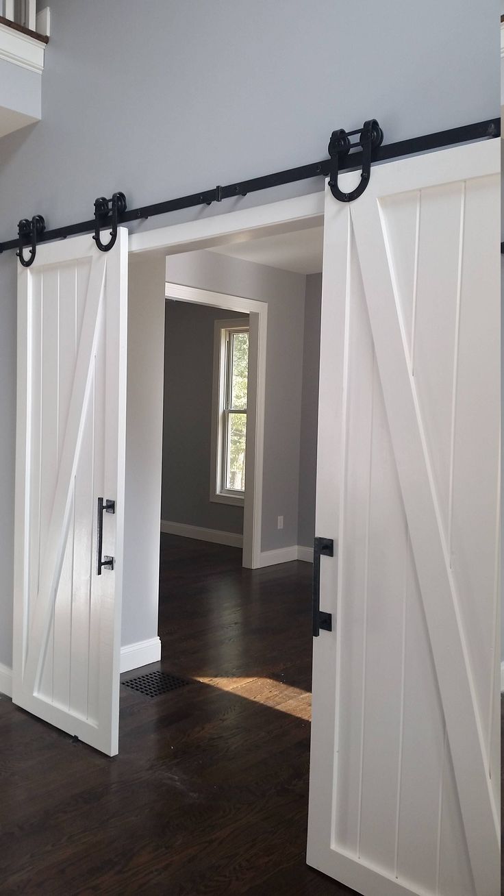 an open door leading to another room with wood floors and hard wood flooring on the other side