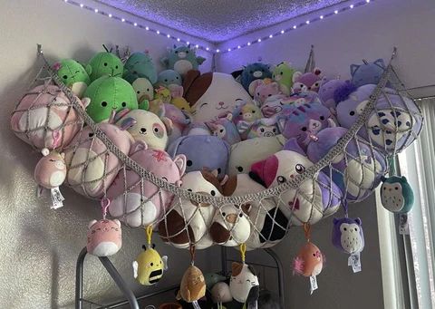 a bunch of stuffed animals are hanging from a rack