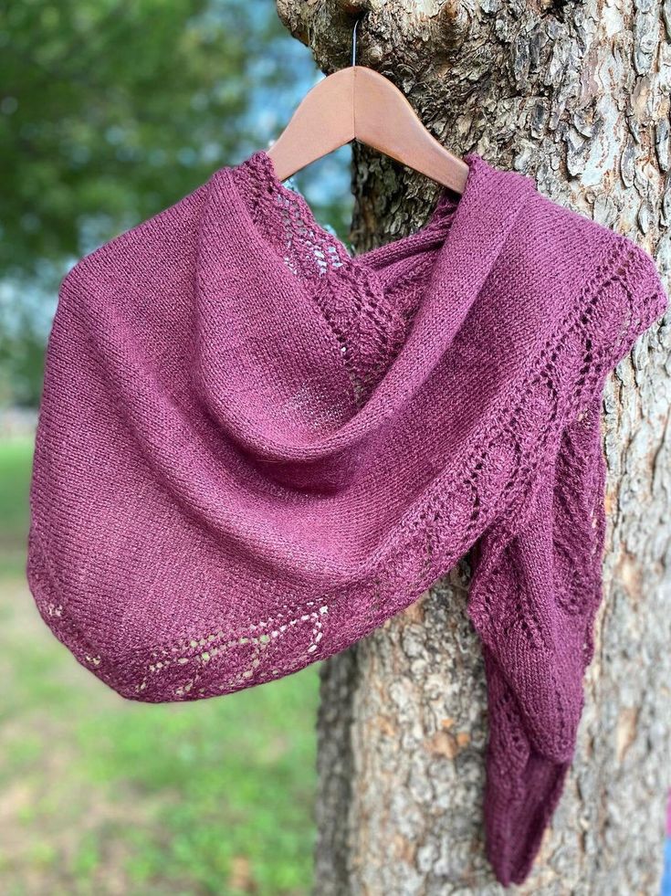 a purple shawl hanging from a tree