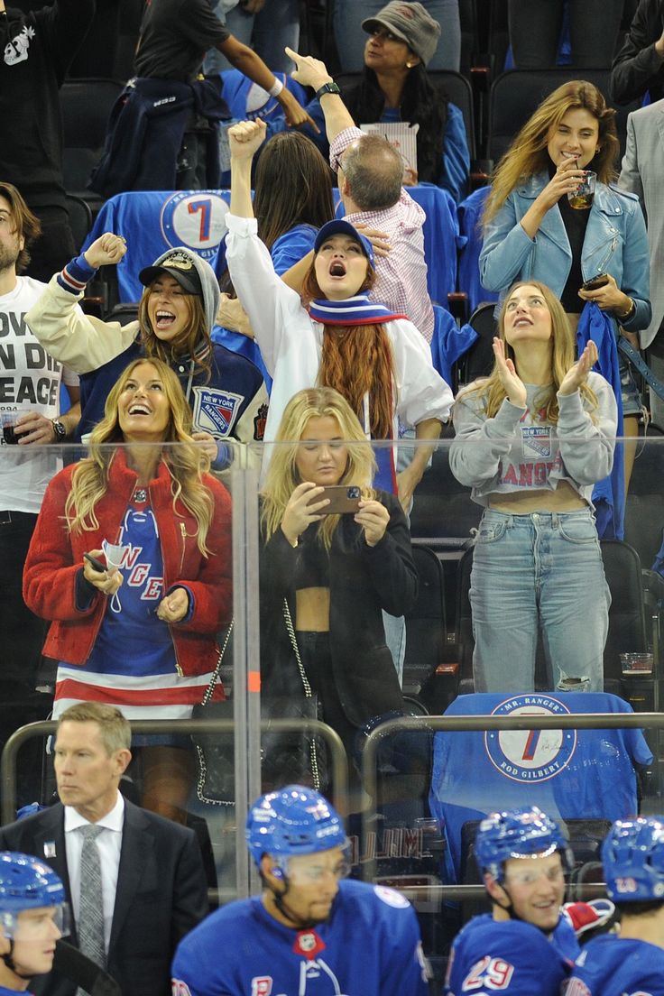 a group of people standing next to each other at a hockey game