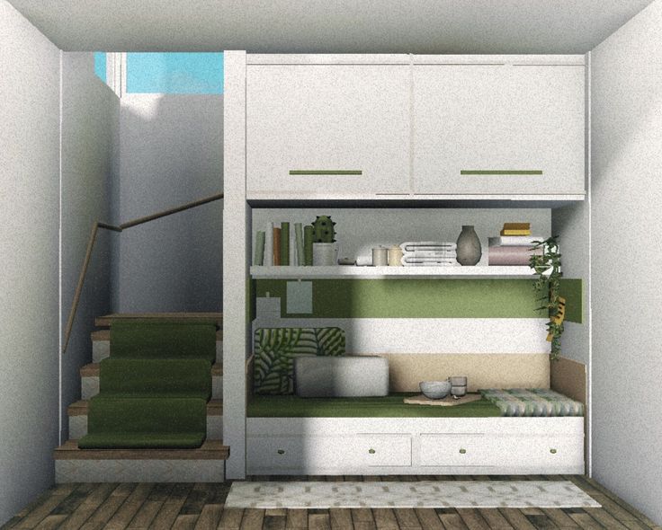 a room with stairs and green carpeted flooring in front of white cupboards