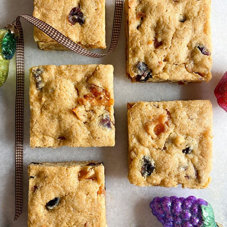 several pieces of fruit and cookie sitting on top of a table