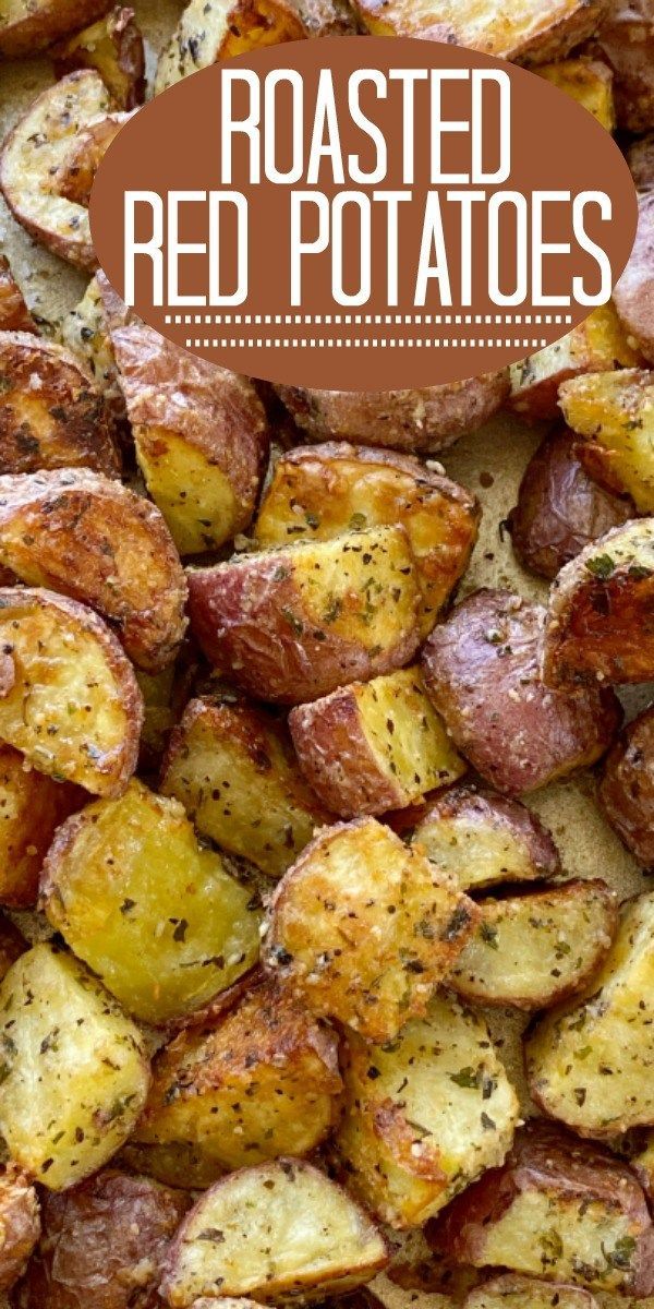 roasted red potatoes with herbs and seasoning on top, in a baking pan text overlay reads roasted red potatoes