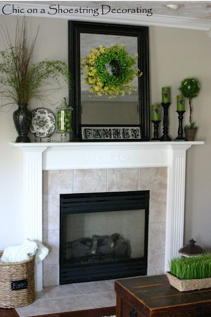 a living room with a fire place and a mirror on the wall above it that says chic on a shoestring decorating