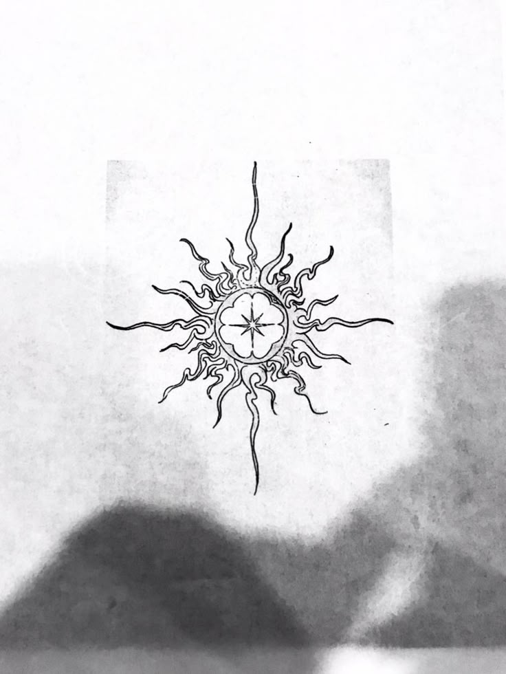 a black and white drawing of a sun in the sky