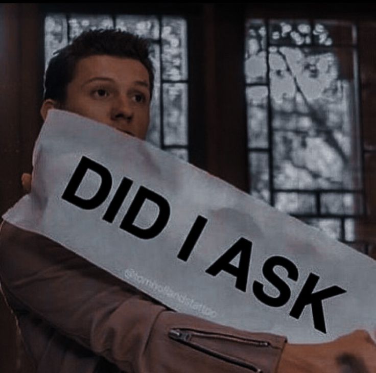 a man holding a sign that says did i ask?