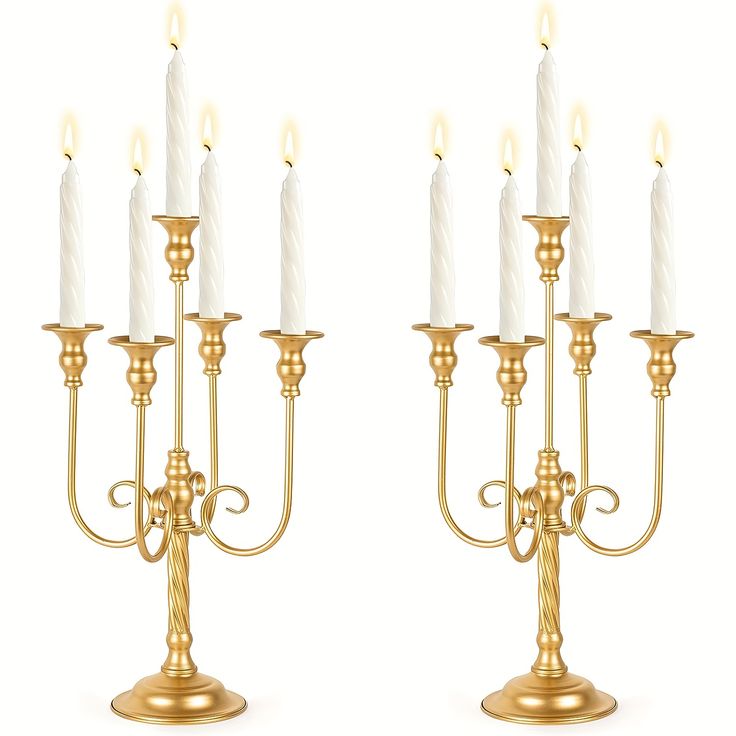 two golden candelabras with white candles on them