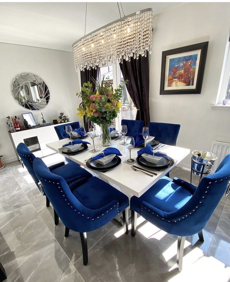 a dining room table with blue chairs around it