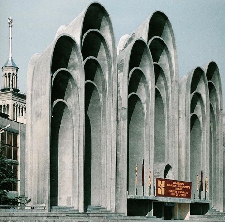 the building is made out of concrete and has arches