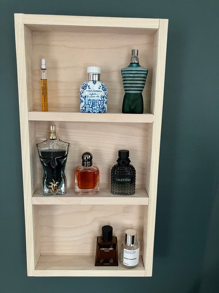 three shelves with different types of perfumes on them