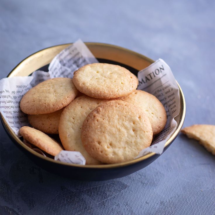 a bowl filled with cookies on top of a table