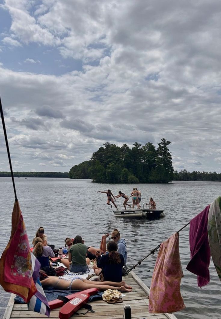 some people are sitting on the dock and having fun