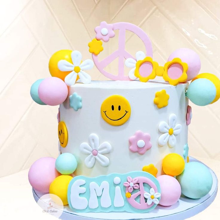 a cake decorated with flowers and smiley faces